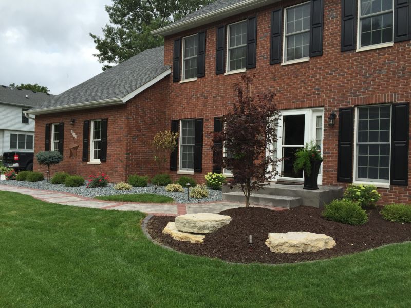 Front of brick home with fresh plantings 