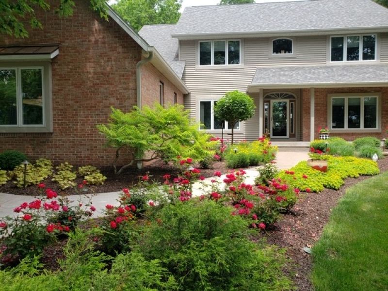 Front of home with greenery and flowers 